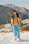 Lucky girl snowboarder in a mountain valley