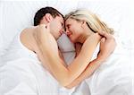 Couple sleeping in bed together