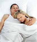 High view of couple sleeping in bed together