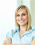 Businesswoman smiling with arms crossed in an office