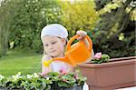 Young girl watering flowers