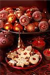 Detail of delicious Christmas cookies with candles in red tone
