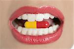 Beauty woman mouth with red lips and medicine pill