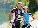 Senior man and young woman on road bike. Copy space