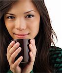 Drinking coffee. Beautiful mixed asian / caucasian woman drinking coffee or tea