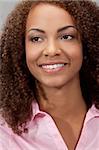 A beautiful mixed race African American girl laying down with perfect teeth and smile