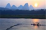 Sunrise with bamboo boat at Yangshuo on the Li River, China