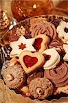 Detail of delicious Christmas cookies with candles in golden tone