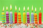 Ten birthday candles on green background