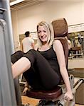 Girl exercing her legs at a health club