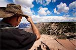 Male hiker looking over the ridge of the Grand Canyon