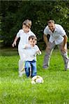 Competition of two little brothers in football in a summer garden