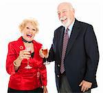 Senior couple laughing and drinking champagne at a holiday party.  Could be Christmas or New Years.  Isolated on white.