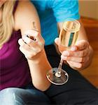 Close-up of couple holding a key and a glass of champagne. Concept of buying house