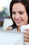 Beautiful businesswoman working in office and drinking coffee