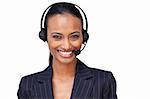 Portrait of a beautiful ethnic businesswoman with a headset on smiling at the camera