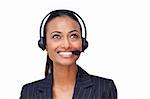 Portrait of a beautiful ethnic businesswoman with a headset on looking upwards