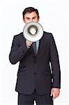 Handsome businessman shouting through a megaphone agaisnt white