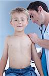 Smiling doctor examinating a child with stethoscope