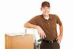 Handsome delivery man leaning on his dolly filled with boxes.  Isolated on white.