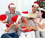 Happy family with Christmas gifts in sofa at home