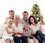 Children pulling crackers in Christmas with their family