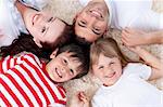 Family lying on floor with heads together