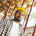 latin american construction worker looking at camera.