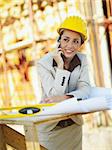 female architect talking on mobile phone in construction site