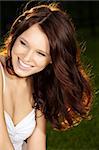 Portrait of beautiful laughing girl with long curly healthy hair