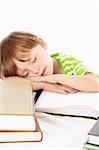 Little boy sleeps on a heap of the books, isolated