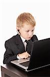 Little boy in a business suit with the computer, isolated