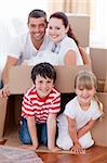 Happy family moving house playing with boxes