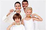 Happy family cleaning their teeth in bathroom