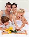 Family eating nutritive breakfast in bedroom