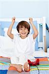 Happy boy playing videogames in his bedroom