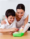 Mother and son making the school lunch in the kitchen