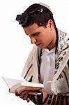 Close up of a young  jewish man with book on white isolated background