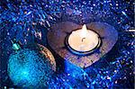 Blue heart candle and Christmas ball in tinsel