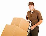 Handsome moving man moves a stack of boxes on his dolly.  Isolated on white.