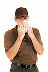 Worker with flu blowing his nose.  Isolated on white.