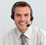 Portrait of a smiling attractive businessman with a headset on