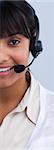 Close-up of a smiling ethnic businesswoman with a headset on