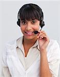 Smiling ethnic young businesswoman working in a call center