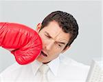 Boxing a businessman in his face while he is working in the office