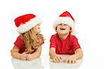 Kids laughing and having fun with christmas hats - isolated