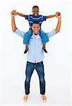 Dad giving son piggyback ride against white background