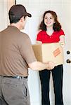 Young woman at home receives a package from a delivery man.