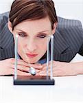 Young businesswoman looking at kinetic balls in the office