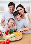 Portrait of  happy parents cooking with their children in the kitchen